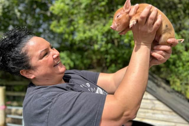 Kew Little Pigs owner Olivia Mikhail with a piglet - Animal News Agency