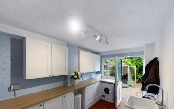 A utility room with plenty of applications which is separate to the home's kitchen.