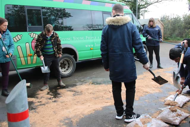 Pupils and staff at Furze Down School clear up the spilt fuel