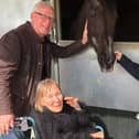 Pictured are three residents greeting one of The Horse Trust's retired horses