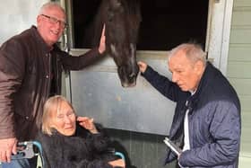 Pictured are three residents greeting one of The Horse Trust's retired horses