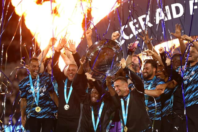 Bolt lifting the trophy along with Ukrainian icon, Andriy Shevchenko (Photo by Alex Pantling/Getty Images)