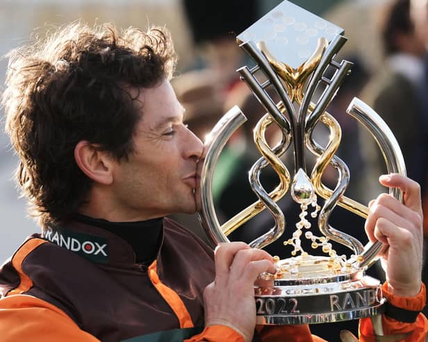 Amateur jockey Sam Waley-Cohen gives the trophy a kiss after winning last year's Grand National on 50/1 novice Noble Yeats in the last ride of his career.