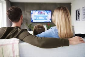 A family enjoy TV together