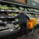 Shoppers in the fruit and vegetables section of a branch of Sainsbury's.