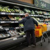 Shoppers in the fruit and vegetables section of a branch of Sainsbury's.