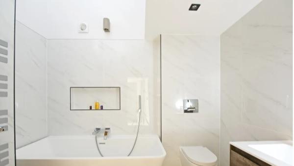 One of the four bathrooms in the home. This one contains a pristine bath, WC, and sink basin.