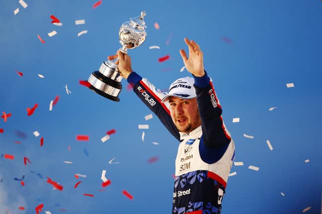 Tom Ingram of Bristol Street Motors Hyundai celebrates with the winner's trophy after clinching the 2022 British Touring Car Championship. (Photo by Ker Robertson/Getty Images)