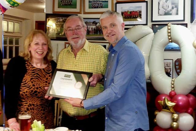 Paul Barnfather of Admiral Taverns presents David and Kath with a certificate of achievement