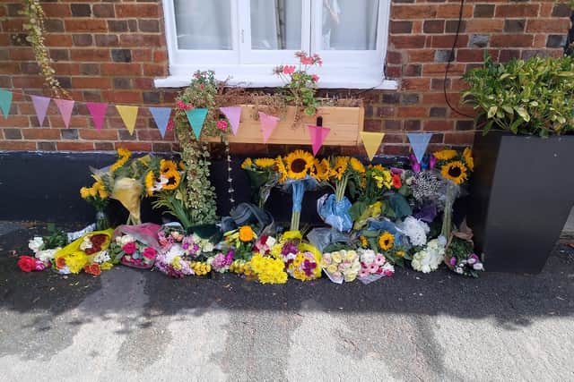 Floral tributes have been left outside The White Swan pub in Whitchurch following Becca's death