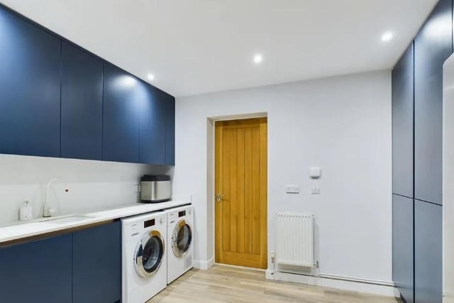 The utility area comprises a range of base and wall mounted units, worktop with inset sink bowl unit, space for washing machine, tumble dryer and American style fridge/freezer. Door to the garage.