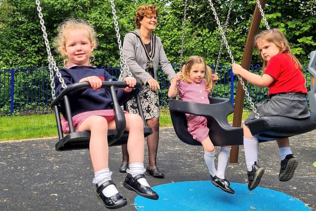 Mayor of Buckingham Anja Shaefer with children on the swings