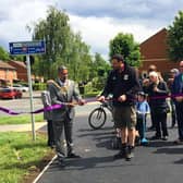 Chairman Dev Dhillon cutting the ribbon to open a new section of the Platinum Way