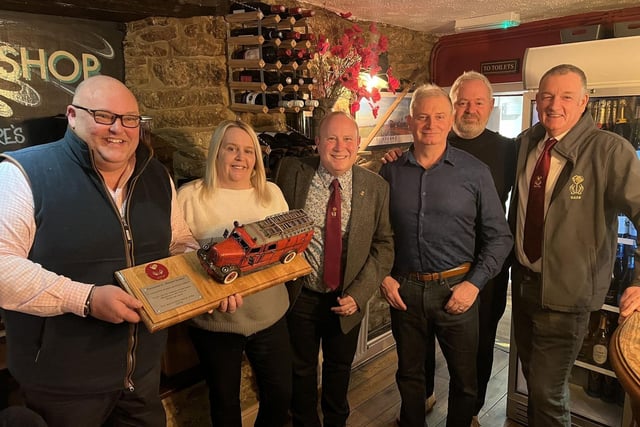 Richard Gordon and Sonya Harvey of Greedy Gordons receive the award presented by Geddington Volunteer Fire Brigade (GVFB) members Pete Faulkner, Graham Story, Graeme Atkins and Simon Clubb.