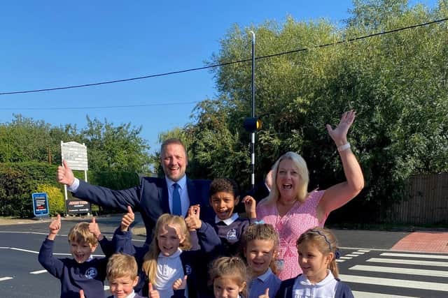 Councillor Steven Broadbent and Headteacher, Eileen Stewart, with pupils at the new crossing