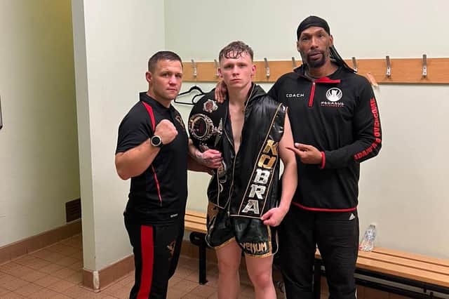 Brandon Cook after his win, alongside Stephen Cook and Michael Graham.