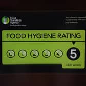 A Food Standards Agency rating sticker on a window of a restaurant