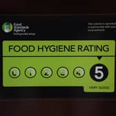 A Food Standards Agency rating sticker on a window of a restaurant