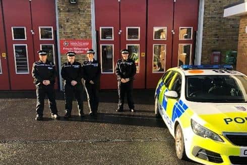 Police officers outside the fire station