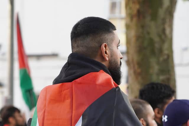 A demonstrator draped in a Palestine flag, photo from Hamzah Israr 0_100media