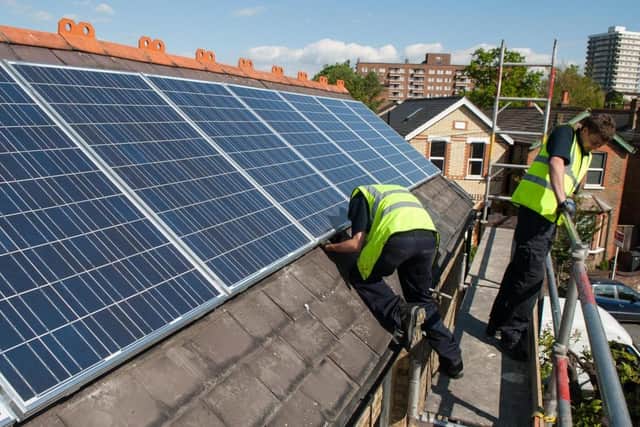 Solar panels being installed on a house roof