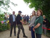 Robbie Cumming cutting the ribbon at the towpath, WCT Chairman to his left and Ros Daniels, Canal & River Trust, and Dr Elaine King, Chiltern National Landscape, to his right.