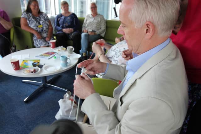 Rob Butler MP concentrates on his knitting