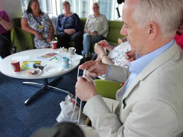 Rob Butler MP concentrates on his knitting