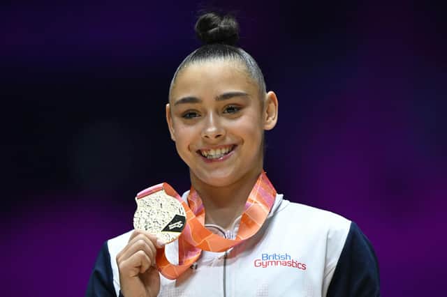 Jessica Gadirova celebrates on the podium with her gold medal after winning the Women's Floor Exercise final at the World Gymnastics Championships in Liverpool. Photo: Getty.
