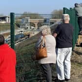 Onlookers watching track laying at the site in early 2023