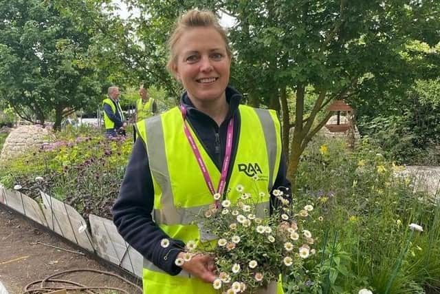 Amy Moffett helps plant up the show garden at Horatio's Garden Chelsea