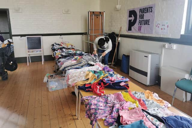 Local parents host a children's clothing swap to promote sustainable living.