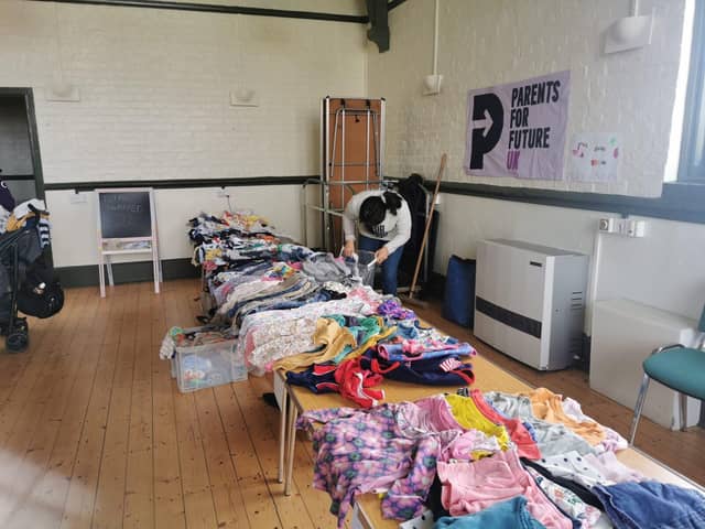 Local parents host a children's clothing swap to promote sustainable living.