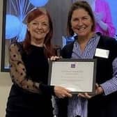 Dr Jocelynne Scutt, left, receives her award from Domestic Abuse Commissioner Nicole Jacobs