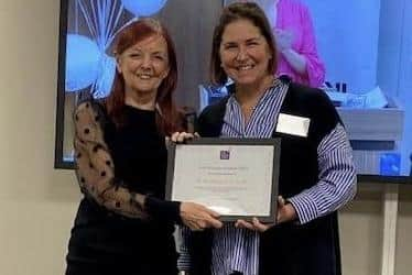 Dr Jocelynne Scutt, left, receives her award from Domestic Abuse Commissioner Nicole Jacobs