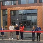 Councillor Anita Cranmer cuts the ribbon with special guests; boxers Adam and Hassan Azim and members of the school council.