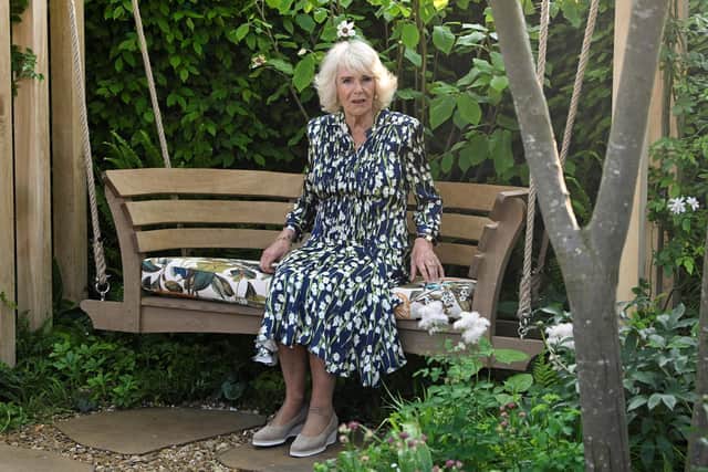 Queen Camilla sits on a bench in the London Square Community Garden at Chelsea Flower Show. Picture: Getty Images