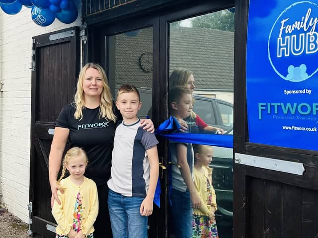 Kim with Reece and Myla, at the family hub opening