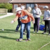 u3a Chairman Malcolm Peckham casts his boule towards the jack. (photo from Peter Dixon)