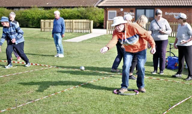 u3a Chairman Malcolm Peckham casts his boule towards the jack. (photo from Peter Dixon)