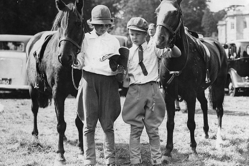 Two children with their riding horses at the Bucks County Show at Hartwell House on 5th September 1935.