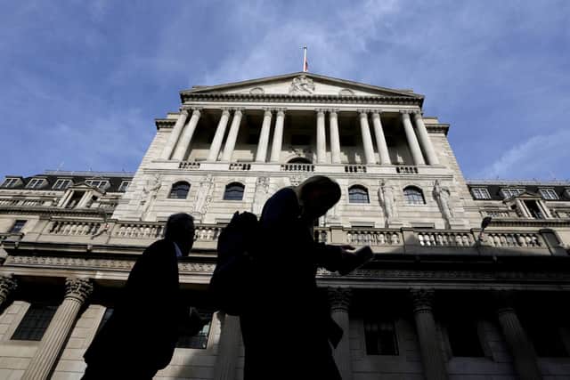 Pedestrians walk past the Bank of England in London. Picture: AP Photo/Kirsty Wigglesworth