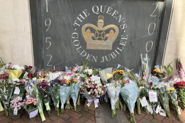 Floral tributes beside the Queen Elizabeth II plaque in Market Square