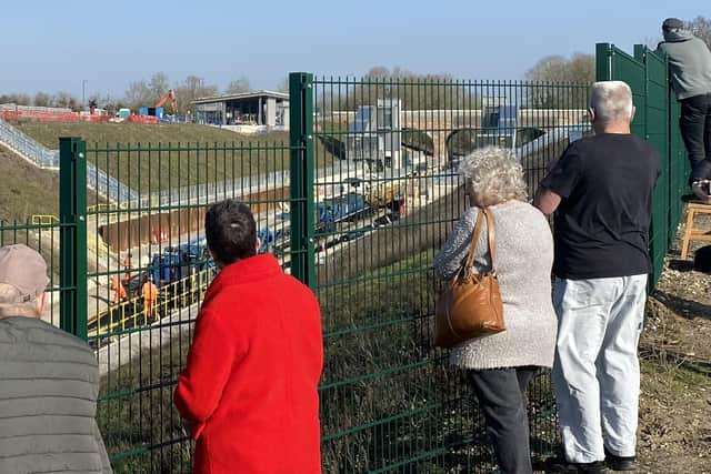 Onlookers watch the work in progress