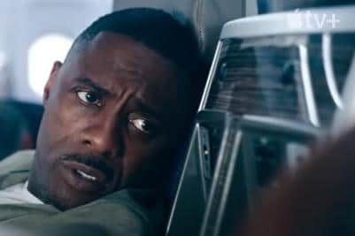 Idris Elba as Sam Nelson addressing a nervous passenger, (photo from Apple TV+)