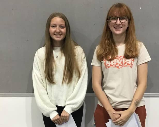 Lottie (L) and Maria (R) collect their results from The Buckingham School