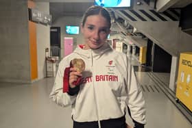 Olivia with her medal. Image supplied by the Newman-Baronius family.
