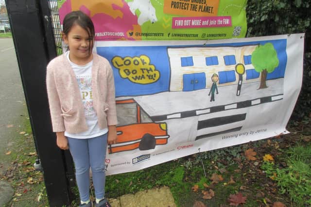 Eight year old Jenna Marie-Bell Hambrook with her award winning road safety banner 