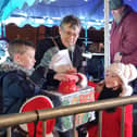 Competition winners Harry and Daisy turn on the Christmas lights with Mayor of Buckingham Margaret Gateley