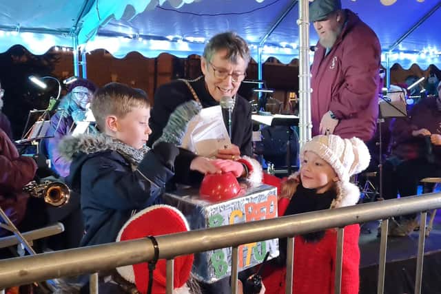 Competition winners Harry and Daisy turn on the Christmas lights with Mayor of Buckingham Margaret Gateley